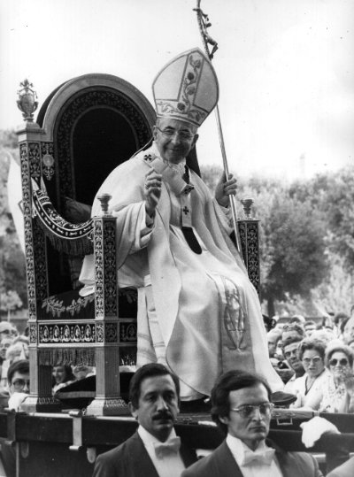 Archival photograph of Pope Paul VI seated while holding the original papal ferula.