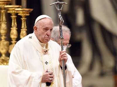 Pope Francis holds the historic bent-arm papal crucifix during a public mass.