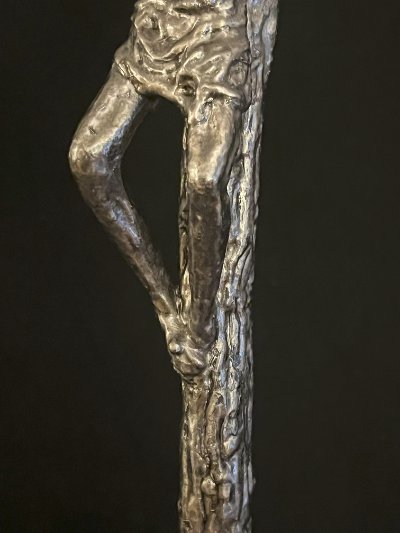 Lateral detail shot of the corpus revealing the dimensional relief of the sculpted figure.