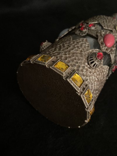 Underneath angled view revealing the flat solid base and the lower perimeter of yellow stones.