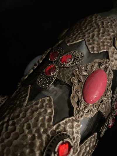 Angled close-up of the decorative casing illustrating the contrast between glass and metalwork.