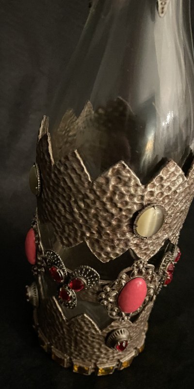 Vertical profile of the glass prop bottle emphasizing the intricate central casing.
