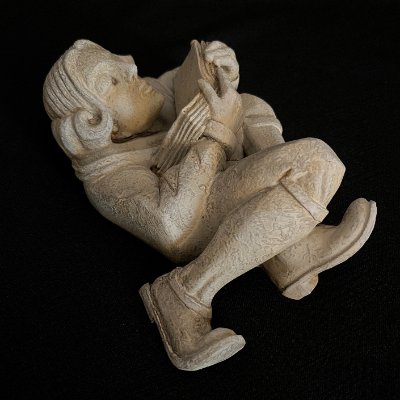 Overhead angled view of the full limestone composite scholar figure.