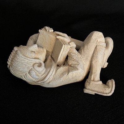 Rear angled view emphasizing the carved boots, legs, and lower torso.