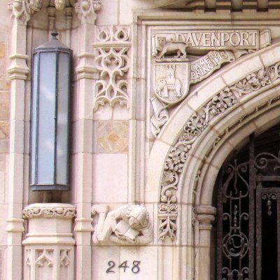 Original stone scholar relief sculpture installed on the Davenport College gate.