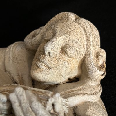 Close-up of the facial features exhibiting simulated mineral stains and weathering.