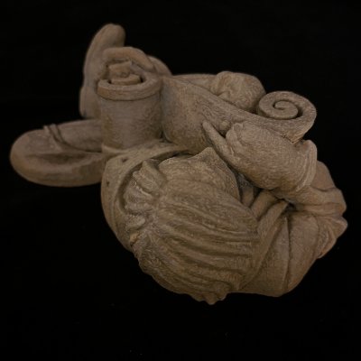 High-angle detail focusing on the textured hair of the gothic scholar sculpture.