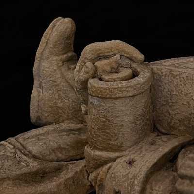 Detailed view of the scholar's fingers grasping the top edge of the open scroll.