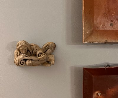 The Yale scroll reader replica displayed as a wall hanging among other art pieces.