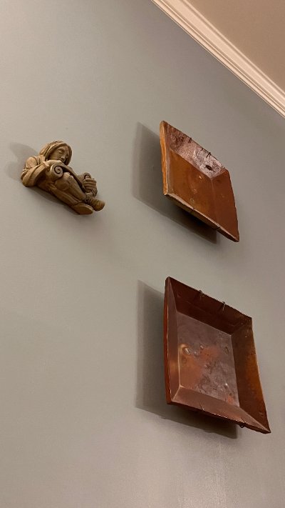 Low-angle view of the limestone replica mounted on a wall in a gallery arrangement.