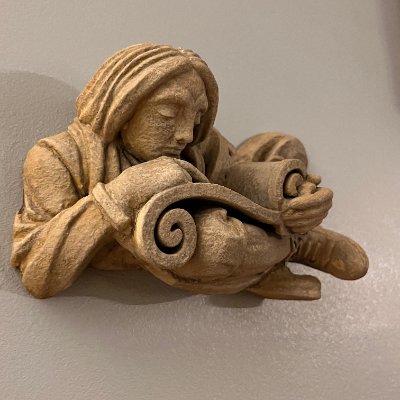 Frontal view of the hand-finished limestone replica displayed on a flat surface.