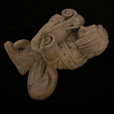 Top-down view of the limestone composite sculpture showing the intricate scrollwork.