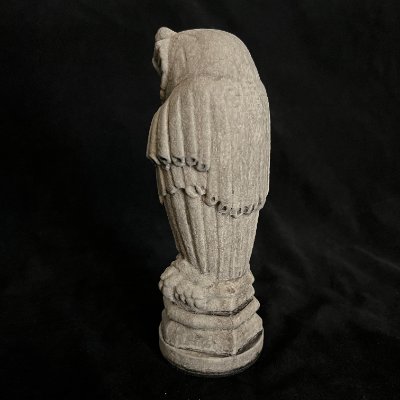 Direct rear view of the Gothic owl replica emphasizing the vertical folds of the stone robe.