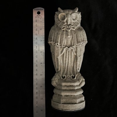 The limestone replica measured against a standard ruler to document its 8-inch height.