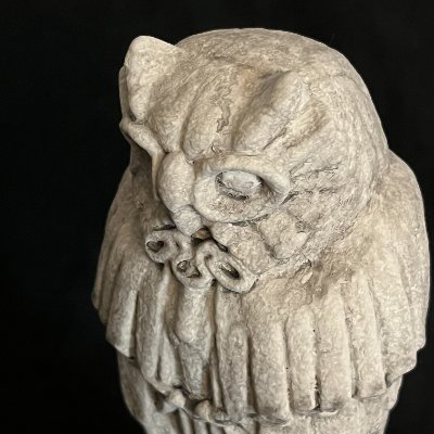 Close-up of the Gothic owl replica featuring round spectacles and textured judge's robes.